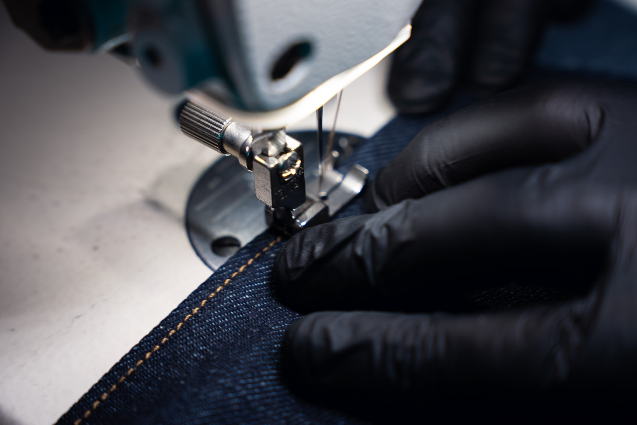 Amber thread running into raw indigo denim.